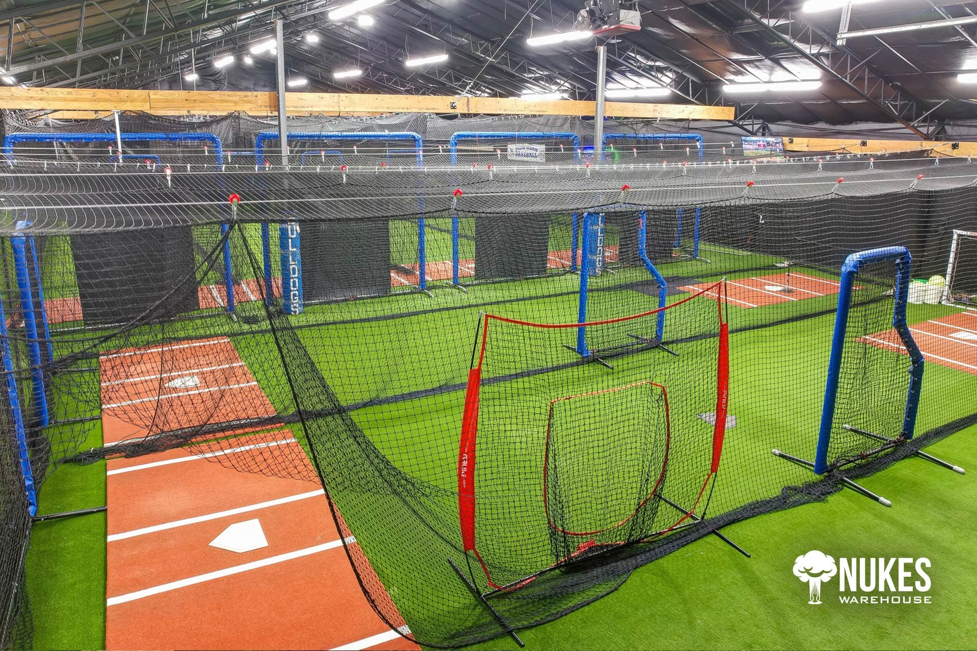 Batting lanes with orange turf and L-screens